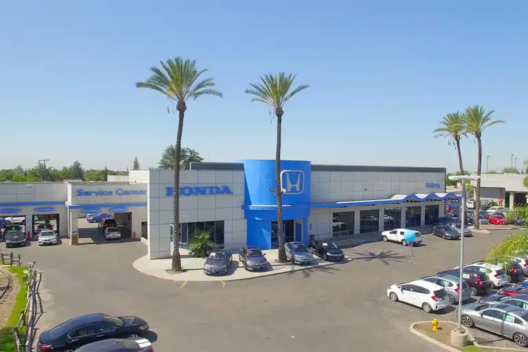 Exterior view of a Honda dealership with cars parked outside.